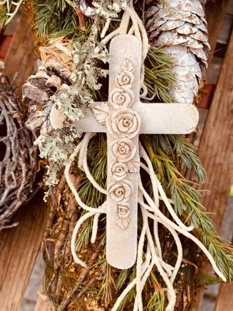 istock Crucifix with floral pattern lying on cones and plants 1066289100