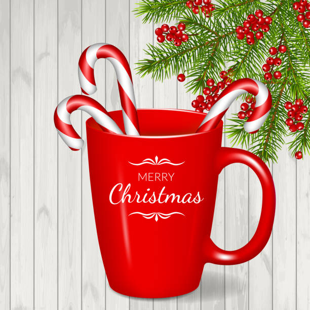 istock Merry Christmas greeting card with fir branches, red cup and candy cane, isolated on wood background. 1066291964