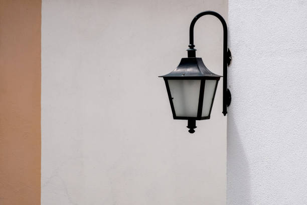 istock Retro style street metal lantern over wall background 1066297532