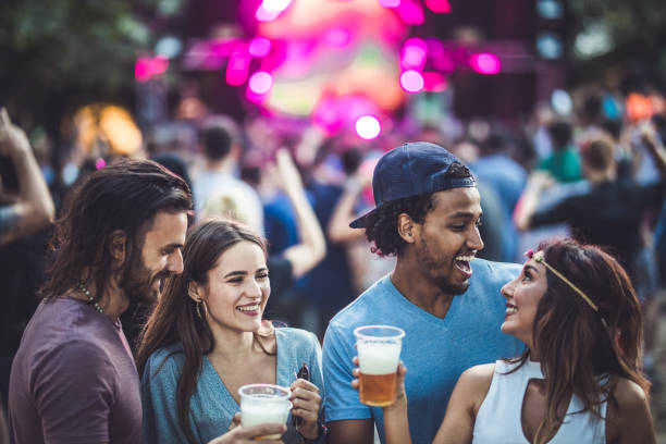 istock Two happy couples talking on a music festival. 1066297740