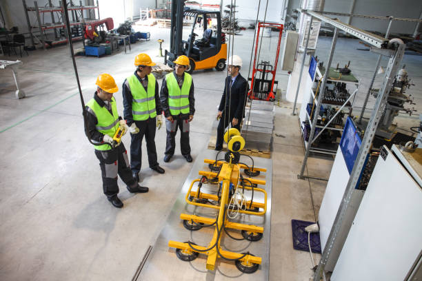 istock Manager and workers at factory 1066297886