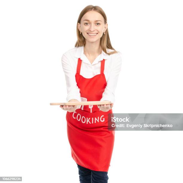 A Woman In A Red Apron In The Hands Wooden Cutting Board Stock Photo - Download Image Now