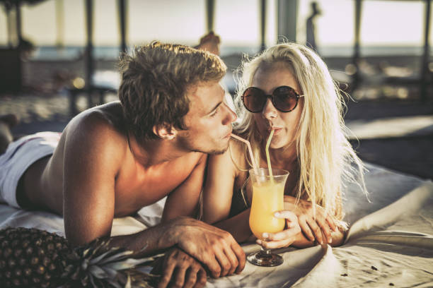 istock Love is sharing summer juice on the beach! 1066309144