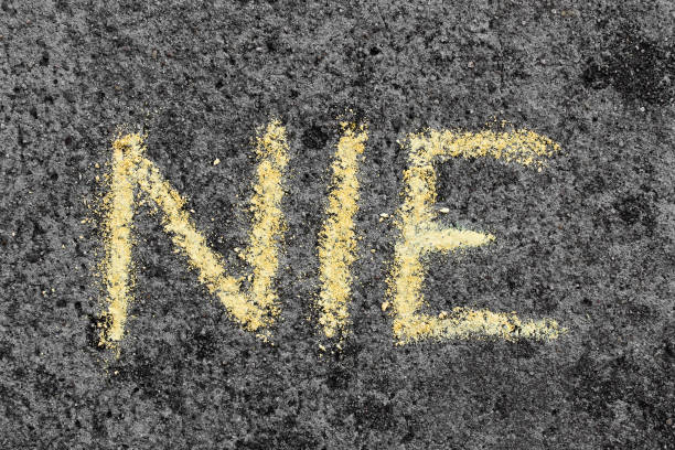 Colorful chalk drawing on asphalt: Polish word NO