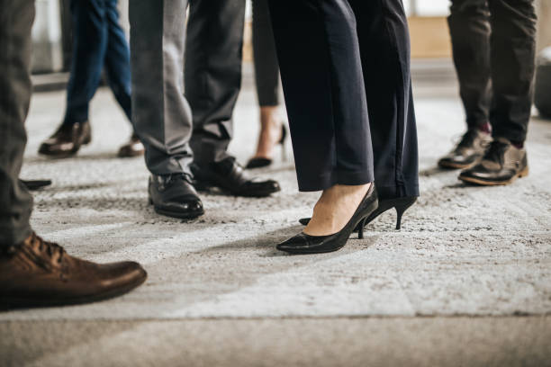 istock Large group of unrecognizable business people standing on carpet. 1066309320
