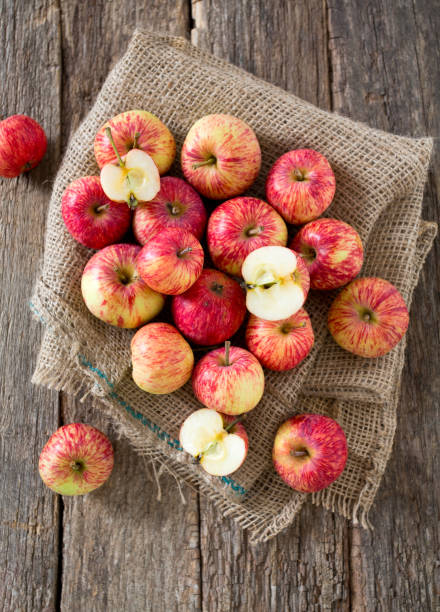 apples on wooden surface apples on wooden surface healthy eating red above studio shot stock pictures, royalty-free photos & images