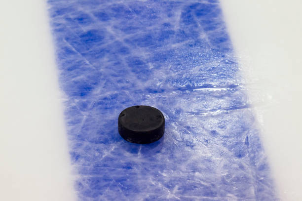 istock Puck on ice hockey rink surface, sport background 1066309552