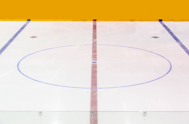 istock Face off blue spot with red line on hockey rink 1066309774