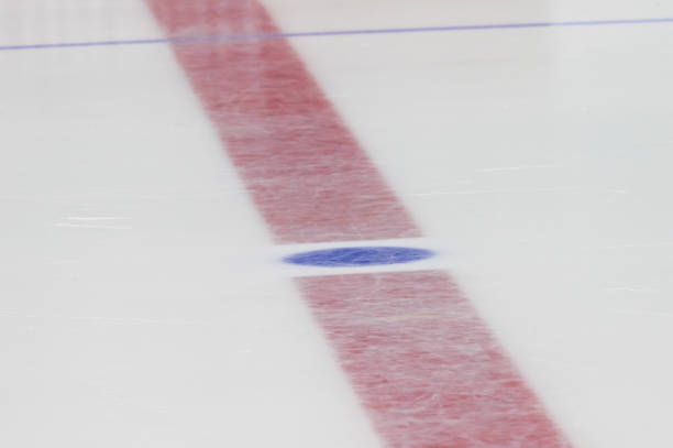 istock Face off blue spot with red line on hockey rink 1066309806