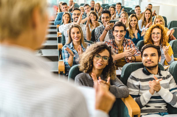 istock Happy college students applauding to their professor in a lecture hall. 1066323744