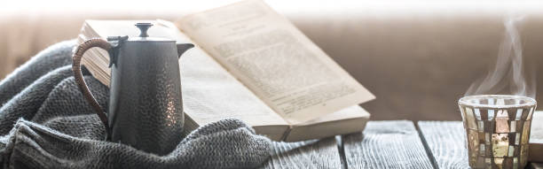 Photo of a soldier in uniform holding closed red book close-up view.