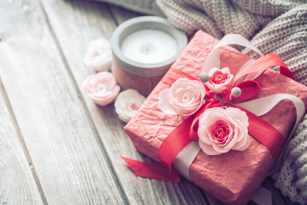 istock Beautiful red gift box on wooden background 1066327258