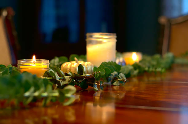 istock Thanksgiving table decorations with candles, pumpkins, and leafy branches 1066328320