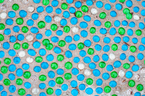 istock colored round shiny glass stones on a sandy surface 1066328876