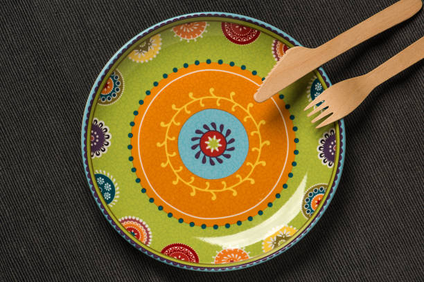 istock Plate with an ornament and a wooden knife and fork. 1066331660