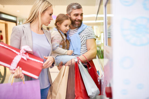 istock Excited family looking at window in mall 1066336748