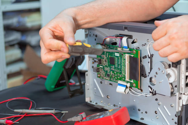 istock Repairman specialist repairs the laser printer in service. 1066336896