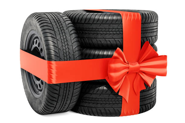 istock Car wheels wrapped ribbon and bow, gift concept. 3D rendering isolated on white background 1066343164