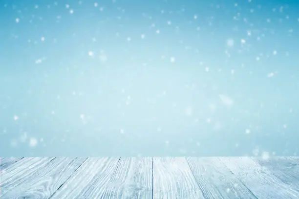 Winter background, falling snow over wooden deck