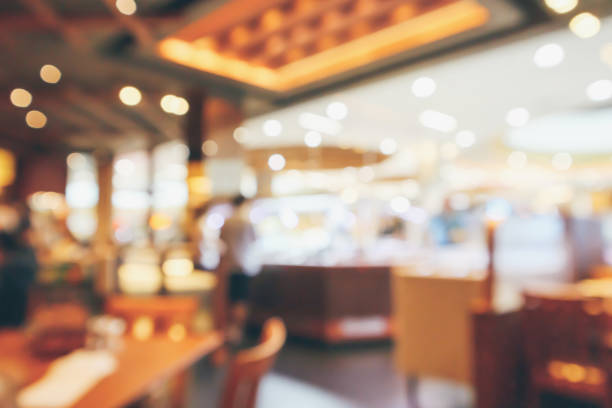 istock Restaurant interior with customer and wood table blur abstract background with bokeh light 1066357966