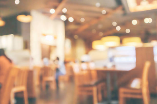 istock Restaurant interior with customer and wood table blur abstract background with bokeh light 1066357972