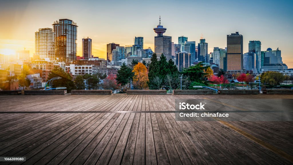view of modern skyscrapers in vancouver empty wooden plank front of city skyline,vancouver,canada. Vancouver - Canada Stock Photo