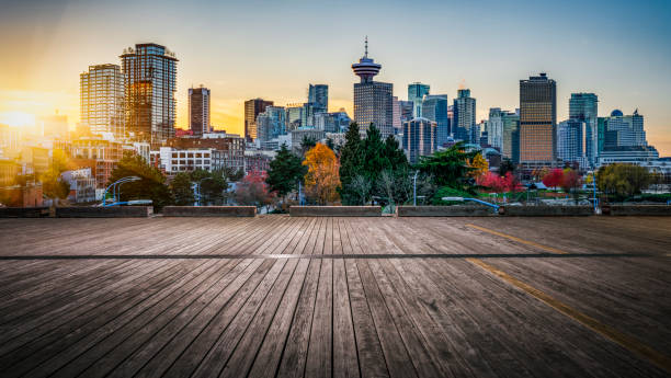 view of modern skyscrapers in vancouver empty wooden plank front of city skyline,vancouver,canada. vancouver canada stock pictures, royalty-free photos & images