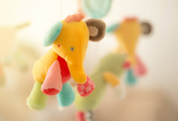 Baby toys hanging paper cut on white background - isolated