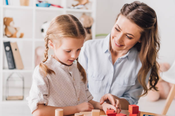 happy mother playing blocks with little child happy mother playing blocks with little child autism photos stock pictures, royalty-free photos & images