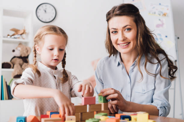 istock happy mother and child looking at camera while playing with blocks 1066370772