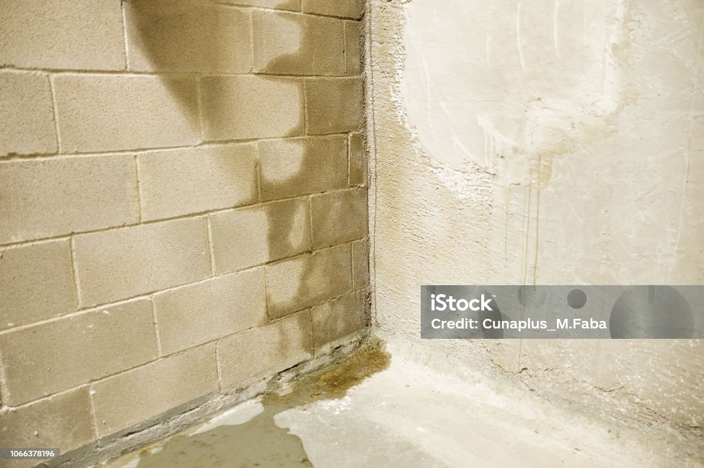 flood in my building Rain water leaks on the wall causing damage Basement Stock Photo