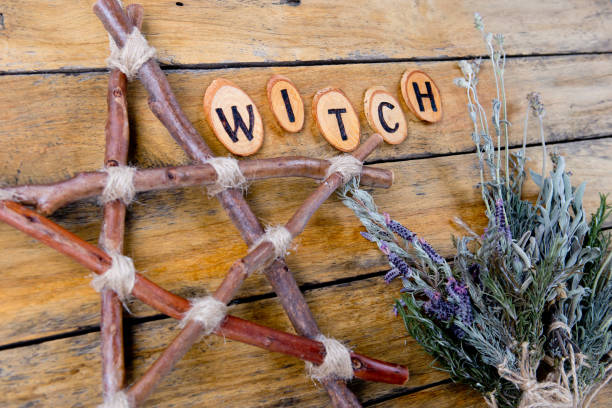 istock Natural Witch - rustic branch pentagram and dried herbs with the word Witch burnt letters 1066381362