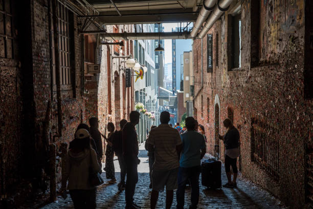 Seattle Washington - Famous Gum Wall in Post Alley Tourist are watch the famous Gum wall at Fish market. Seattle, Washington State, Famous Place, Alley, Dirty chewed bubblegum stock pictures, royalty-free photos & images