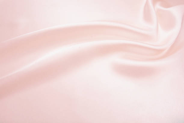 istock Charming smooth satin and silk pink fabric for backgrounds. Elegant abstract upholstery use for holidays 1066389470