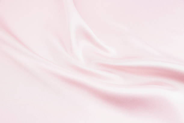 istock Charming smooth satin and silk pink fabric for backgrounds. Elegant abstract upholstery use for holidays 1066389496