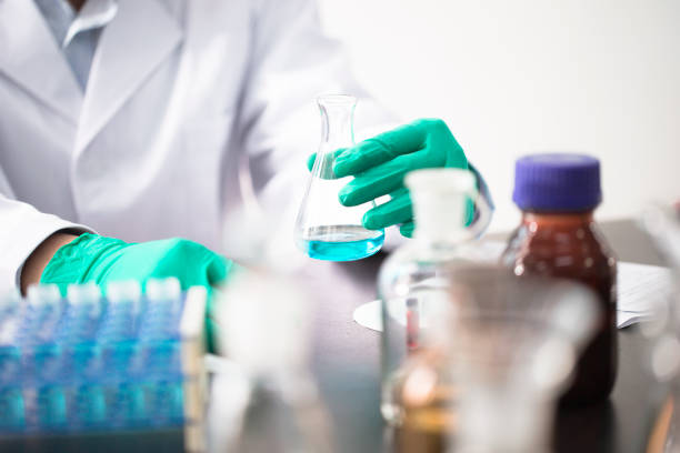 Laboratory flasks with green liquid, 3D rendering isolated on white background