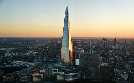 London, England - October 19, 2018 - The Shard skyscraper in downtown London, along the South Bank of the Thames River at dusk.