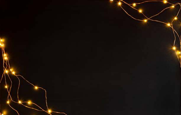 istock Christmas lights garland border over white background. Flat lay, copy space. 1066408634