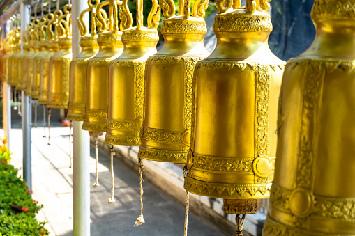 Brass bell lined in Thai temples. For people to knock with good luck and fend off bad.