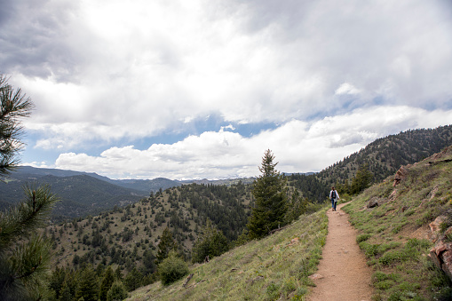 woman hiking in mountain trail in Colorado