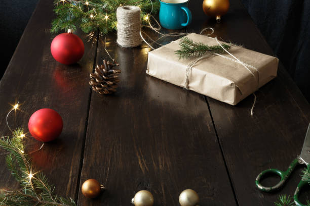 istock Christmas ornaments gift boxes wooden table Rustic Christmas background Wrapping presents 1066434096