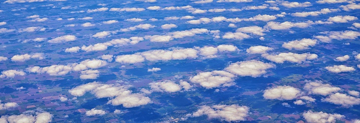 Aerial Cloudscape view over midwest states on flight over Colorado, Kansas, Missouri, Illinois, Indiana, Ohio and West Virginia during autumn. Grand sweeping views of landscape and clouds. Views of crops, rivers, plains, mountain and cloud patterns. Top view texture of clouds, USA.