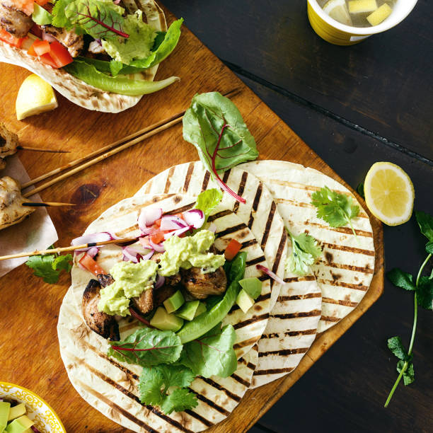 istock Dinner table with tacos grill with vegetable salsa, guacamole sauce, chicken 1066434626