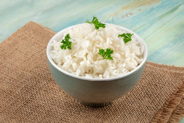 istock A bowl of cooked white long rice on rustic textures with a place for text 1066436590