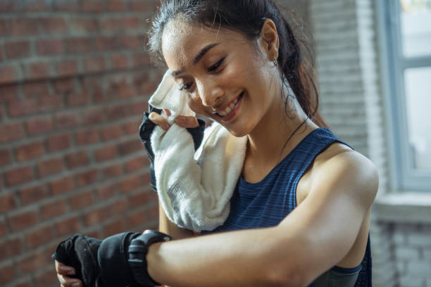 Asian girl exercising in gym she tired and She has sweat on her face. Asian girl exercising in gym she tired and She has sweat on her face. carpet runner stock pictures, royalty-free photos & images