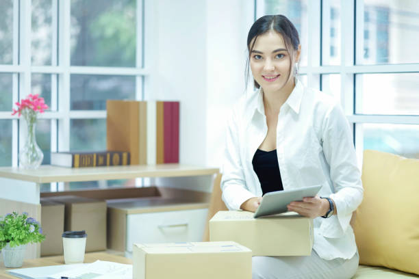 istock Business owner using tabtet computer confirm and check packing list order, Pack boxes, Shipping parcel package and Delivery shopping online. 1066456590