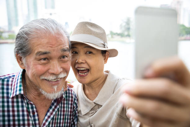 istock Thai senior couple take a selfie on vacation 1066464300