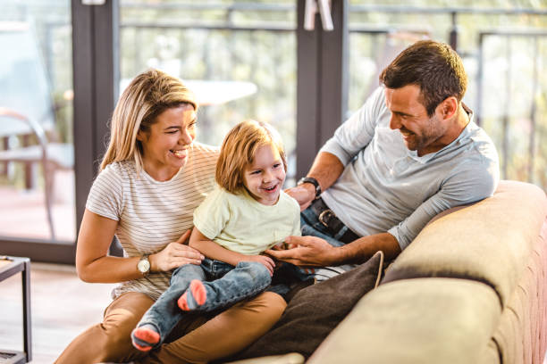 istock Cheerful parents having fun with their small boy at home. 1066465364