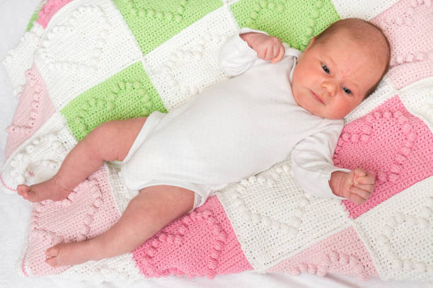 istock Newborn baby is lying on back on knitted blanket 1066471912