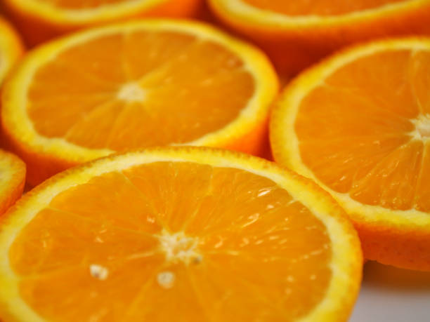 istock tropical citrus fruit - bright orange orange sliced into slices 1066472340